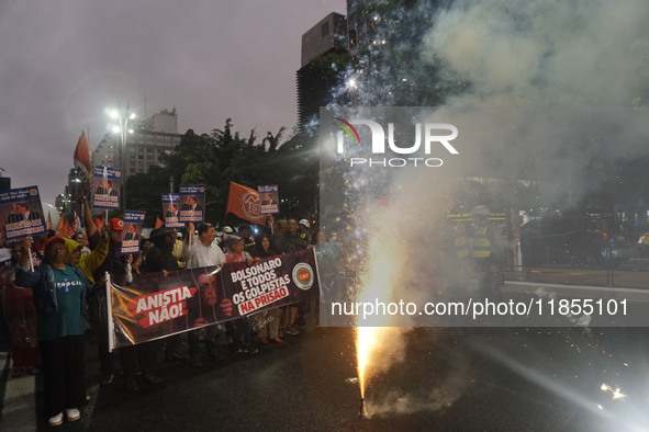 Demonstrators hold banners demanding the imprisonment of Brazilian former President Jair Bolsonaro during a protest in defense of democracy...