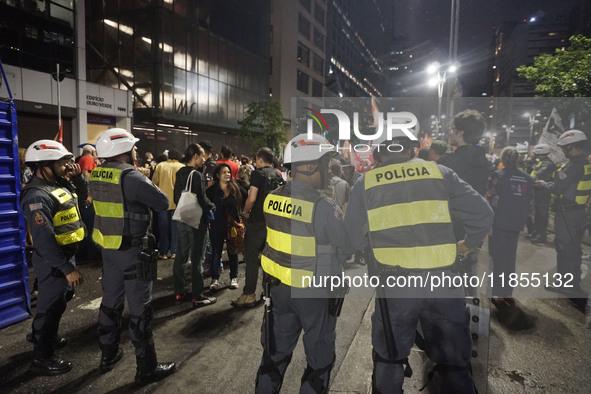 Demonstrators hold banners demanding the imprisonment of Brazilian former President Jair Bolsonaro during a protest in defense of democracy...