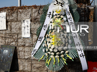 A condolence wreath with the message 'People Power Party, the people are not fools' is placed at the main gate of the National Assembly in Y...