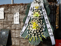 A condolence wreath with the message 'People Power Party, the people are not fools' is placed at the main gate of the National Assembly in Y...