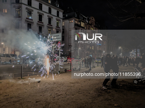 In Frankfurt am Main, Hesse, Germany, on January 1, 2024, people celebrate New Year's Eve by setting off fireworks, bangers, and firecracker...