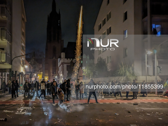 In Frankfurt am Main, Hesse, Germany, on January 1, 2024, people celebrate New Year's Eve by setting off fireworks, bangers, and firecracker...