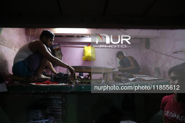 Workers make English calendars ahead of New Year 2025 at a workshop in Kolkata, India, on December 11, 2024. 