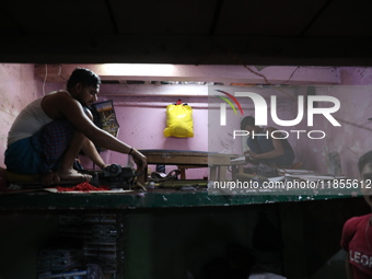 Workers make English calendars ahead of New Year 2025 at a workshop in Kolkata, India, on December 11, 2024. (