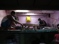 Workers make English calendars ahead of New Year 2025 at a workshop in Kolkata, India, on December 11, 2024. (