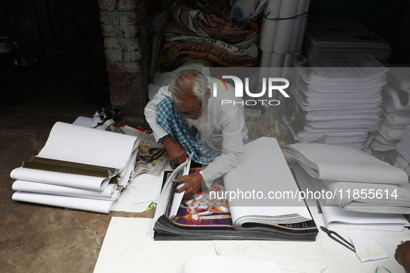 A worker makes English calendars ahead of New Year 2025 in Kolkata, India, on December 11, 2024. 