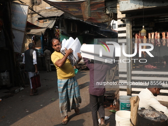 Workers carry English calendars ahead of New Year 2025, at a workshop in Kolkata, India, on December 11, 2024. (