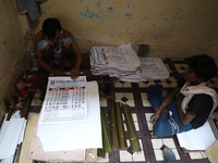 A worker makes English calendars ahead of New Year 2025 in Kolkata, India, on December 11, 2024. (