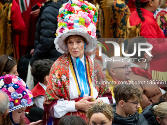 Women from a folk group wear hats with flowers as they wait for the arrival of Pope Francis during the weekly general audience at Paul-VI ha...