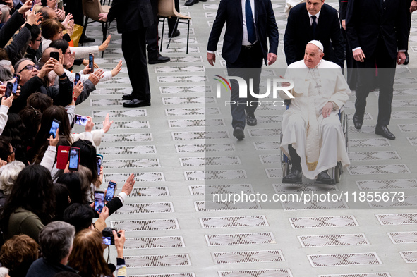 Pope Francis greets people at the end of the weekly general audience at Paul-VI hall in The Vatican, on December 11, 2024. 