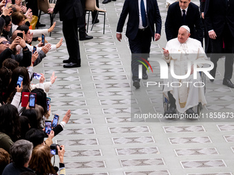 Pope Francis greets people at the end of the weekly general audience at Paul-VI hall in The Vatican, on December 11, 2024. (