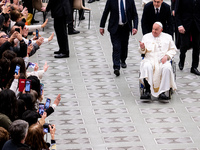 Pope Francis greets people at the end of the weekly general audience at Paul-VI hall in The Vatican, on December 11, 2024. (