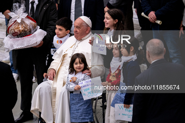 Pope Francis greets people at the end of the weekly general audience at Paul-VI hall in The Vatican, on December 11, 2024. 