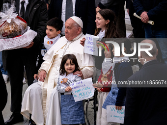 Pope Francis greets people at the end of the weekly general audience at Paul-VI hall in The Vatican, on December 11, 2024. (