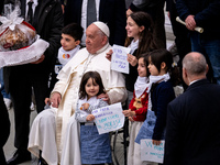 Pope Francis greets people at the end of the weekly general audience at Paul-VI hall in The Vatican, on December 11, 2024. (