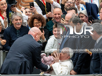 Pope Francis greets people at the end of the weekly general audience at Paul-VI hall in The Vatican, on December 11, 2024. (