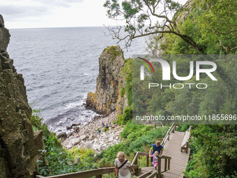 People visit Jons Kapel cliff near Hasle on Bornholm Island in Denmark on August 5, 2024. (