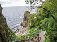 People visit Jons Kapel cliff near Hasle on Bornholm Island in Denmark on August 5, 2024. (