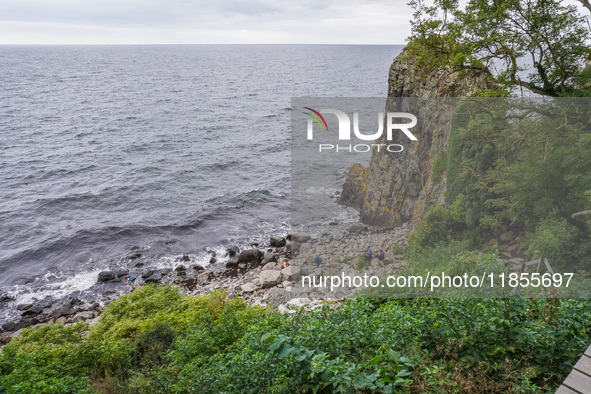 People visit Jons Kapel cliff near Hasle on Bornholm Island in Denmark on August 5, 2024. 