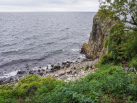 People visit Jons Kapel cliff near Hasle on Bornholm Island in Denmark on August 5, 2024. (