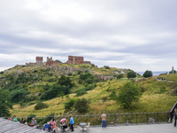 People spend free time in a coffee shop near the Hammershus castle ruins on Bornholm Island, Denmark, on August 5, 2024. (