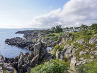 A general view of the rocky coast of the Baltic Sea in Gudhjem, Bornholm Island, Denmark, on August 6, 2024 (