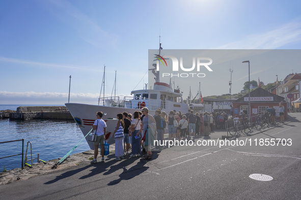 People wait for the Christianso ship in Gudhjem, Bornholm Island, Denmark, on August 6, 2024 