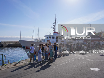 People wait for the Christianso ship in Gudhjem, Bornholm Island, Denmark, on August 6, 2024 (