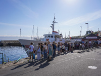 People wait for the Christianso ship in Gudhjem, Bornholm Island, Denmark, on August 6, 2024 (