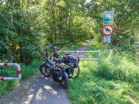 Two electric bikes park at the entrance to the bike lane in Ronne, Bornholm Island, Denmark, on August 6, 2024. (