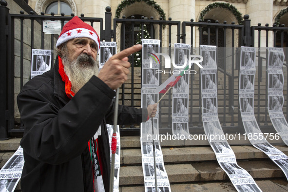 A lone protester stands against former Prime Minister Boyko Borisov, who served between 2009 and 2021 and is the leader of the party GERB (C...