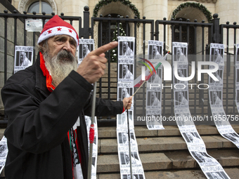 A lone protester stands against former Prime Minister Boyko Borisov, who served between 2009 and 2021 and is the leader of the party GERB (C...