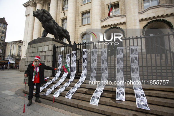 A lone protester stands against former Prime Minister Boyko Borisov, who served between 2009 and 2021 and is the leader of the party GERB (C...