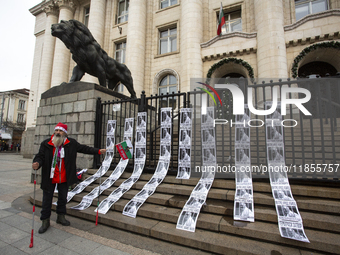 A lone protester stands against former Prime Minister Boyko Borisov, who served between 2009 and 2021 and is the leader of the party GERB (C...