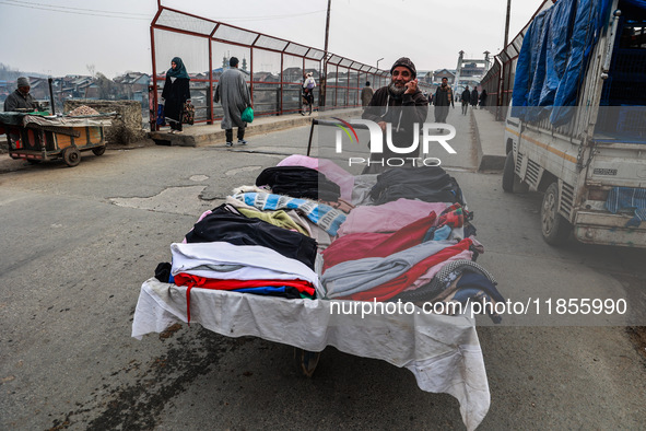 A man sells woolen clothes on a cold day in Sopore, Jammu and Kashmir, India, on December 11, 2024. 