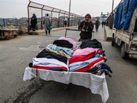 A man sells woolen clothes on a cold day in Sopore, Jammu and Kashmir, India, on December 11, 2024. (