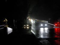 Cars move along a dark street in the Rusanivka neighborhood during a power cut in Kyiv, Ukraine, on December 7, 2024. (