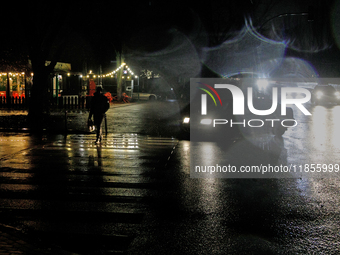 A pedestrian crosses a dark street in the Rusanivka neighborhood during a power cut in Kyiv, Ukraine, on December 7, 2024. NO USE RUSSIA. NO...