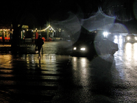 A pedestrian crosses a dark street in the Rusanivka neighborhood during a power cut in Kyiv, Ukraine, on December 7, 2024. NO USE RUSSIA. NO...