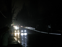 Cars move along a dark street in the Rusanivka neighborhood during a power cut in Kyiv, Ukraine, on December 7, 2024. (