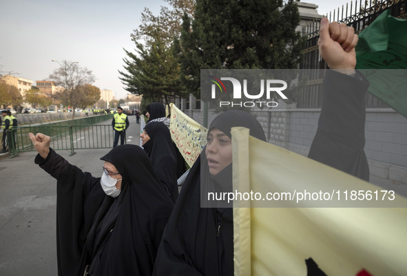 Two veiled Iranian women shout slogans while participating in a rally to support the Hijab bill outside the Iranian Parliament building in T...