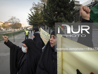 Two veiled Iranian women shout slogans while participating in a rally to support the Hijab bill outside the Iranian Parliament building in T...