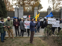 A small group of Iranian men holds placards while participating in a rally to support the Hijab bill outside the Iranian Parliament building...