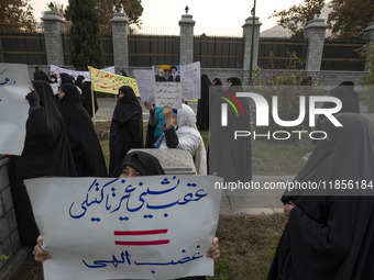 A veiled Iranian woman holds a placard with Persian script that reads, ''Non-tactical retreat equals divine wrath,'' during a rally to suppo...