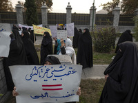 A veiled Iranian woman holds a placard with Persian script that reads, ''Non-tactical retreat equals divine wrath,'' during a rally to suppo...