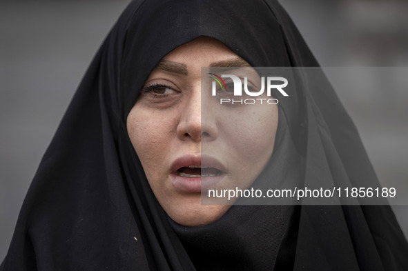 A veiled Iranian woman shouts slogans while participating in a rally to support the Hijab bill outside the Iranian Parliament building in Te...