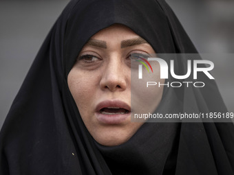 A veiled Iranian woman shouts slogans while participating in a rally to support the Hijab bill outside the Iranian Parliament building in Te...