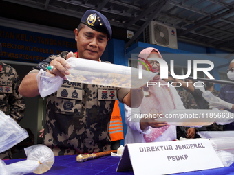 The Director General of Marine Resources and Fisheries Supervision (PSDKP), Pung Nugroho Saksono, gives a press statement while showing evid...