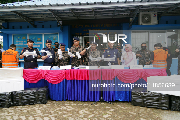 The Director General of Marine Resources and Fisheries Supervision (PSDKP), Pung Nugroho Saksono, and his staff give a press statement while...