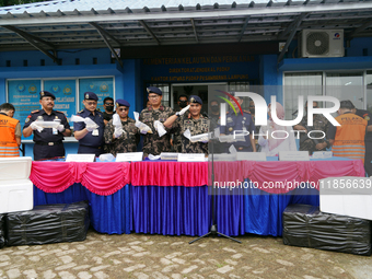 The Director General of Marine Resources and Fisheries Supervision (PSDKP), Pung Nugroho Saksono, and his staff give a press statement while...